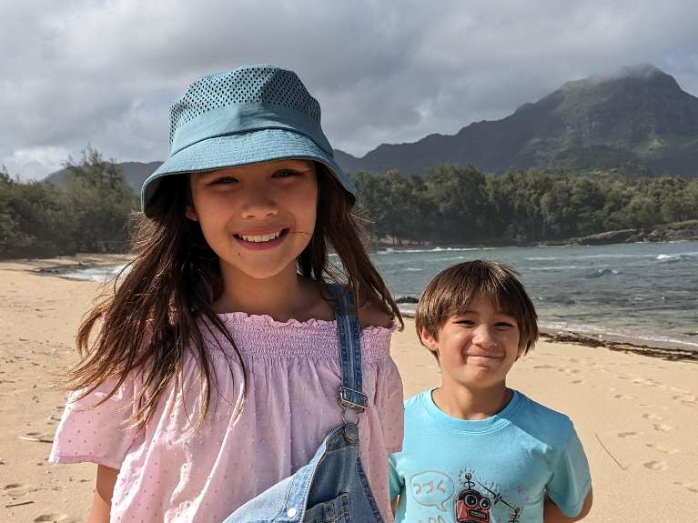 young children smiling on a tropical beach